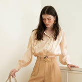 Textured silk blouse with pleated long sleeves and soft sheen finish for elegant styling